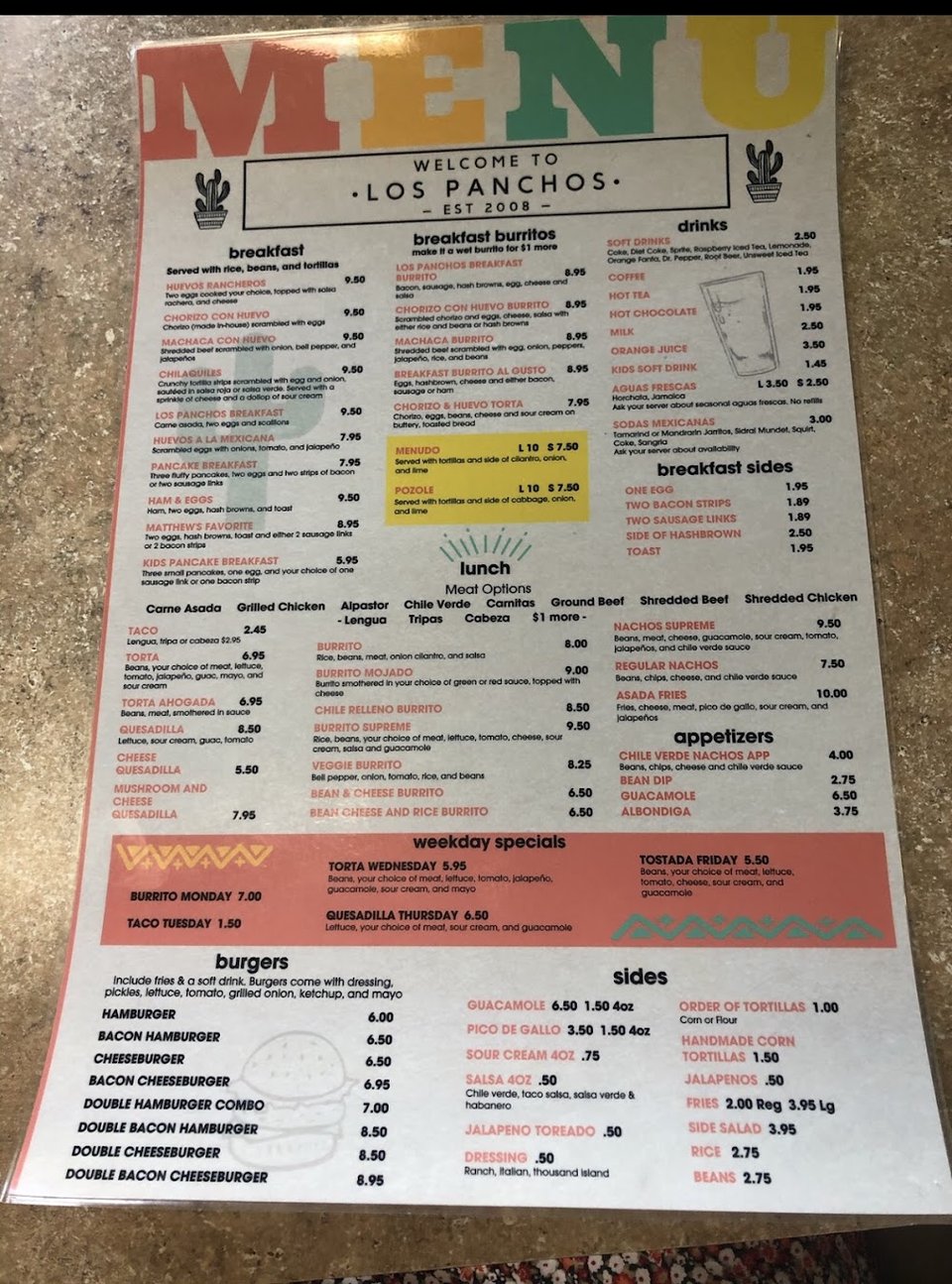 Restaurant menu laid out on a clean counter.